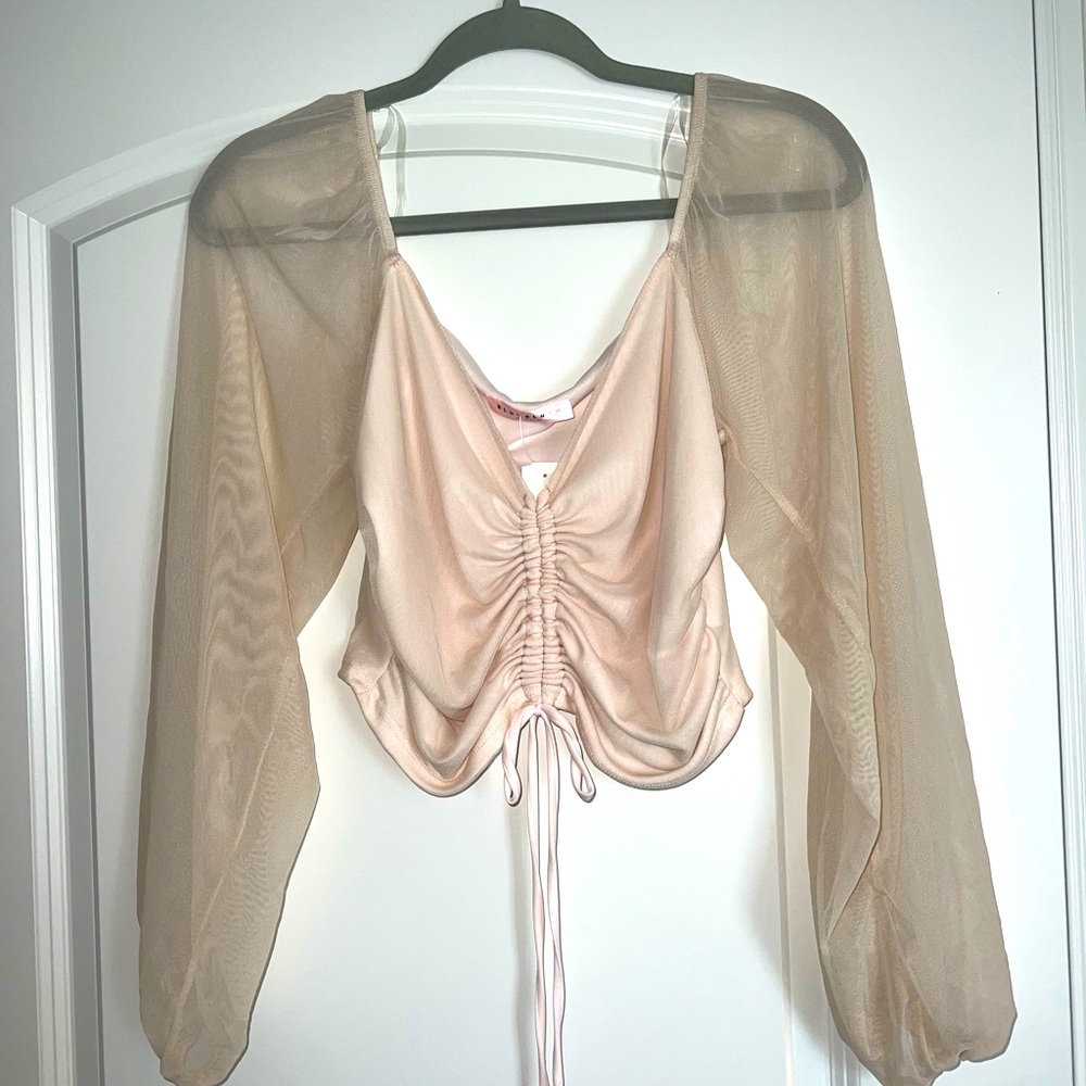light pink top with sheer bell sleeves